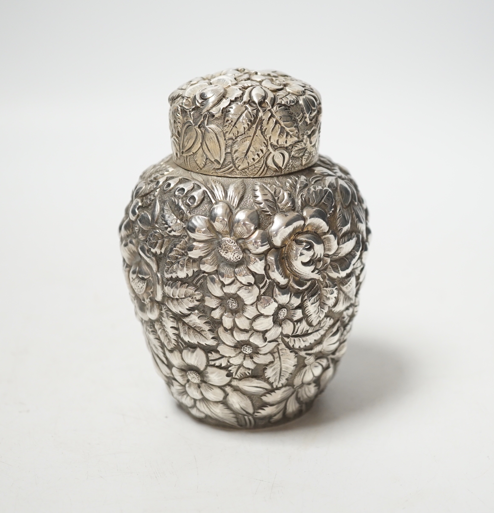 An early 20th century American Galt Bros. sterling tea caddy, embossed with flowers, 10.3cm, 4.7oz.